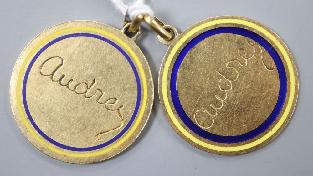 Two yellow metal and enamel pendant medallions, both engraved Audrey, 26mm, gross 14.9 grams.